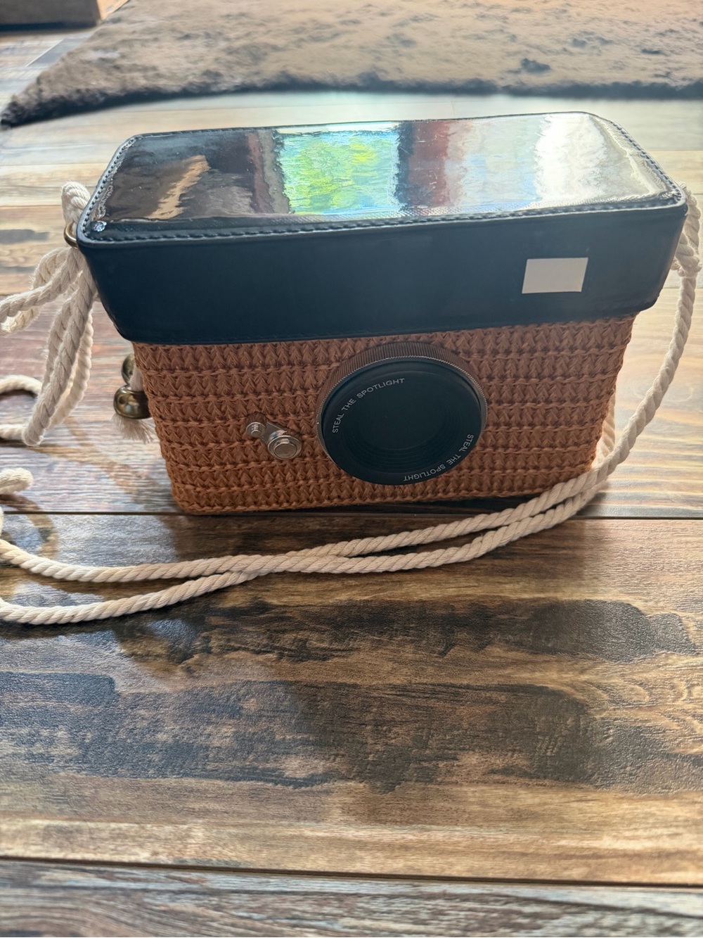 Vintage-Style Brown Straw Camera Bag with Black Top and Cream Strap